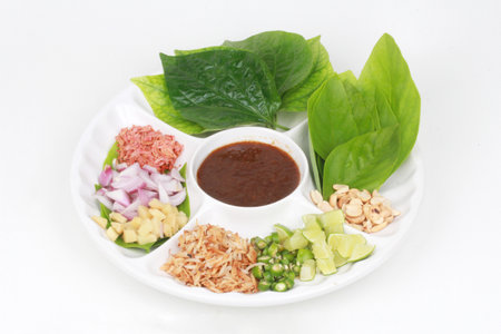 Thailand Vietnamese dessert ,Leaf wrapped bite size appetizer, grated coconut, ginger, shallots,peanuts, dried shrimps, lime, chillies and edible tree leaves, Call Miang Kum in  Thaiの写真素材