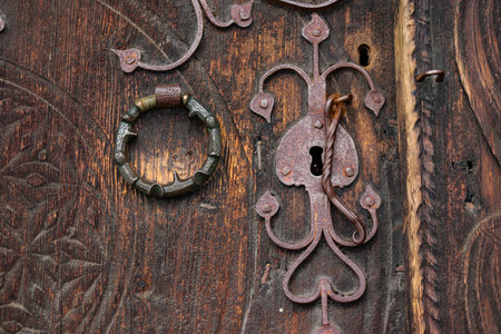 old wooden door with ironwork forged in cast ironの写真素材