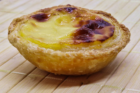 sweet delight of pastel de belen or nata portuguese on bamboo tray