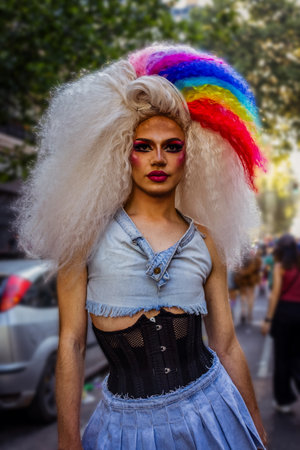 drag queen elegantly dressed to celebrate pride day with strands of rainbow dyed hairのeditorial素材