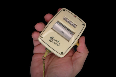 hand holding an old photographic selenium photometer on black backgroundのeditorial素材