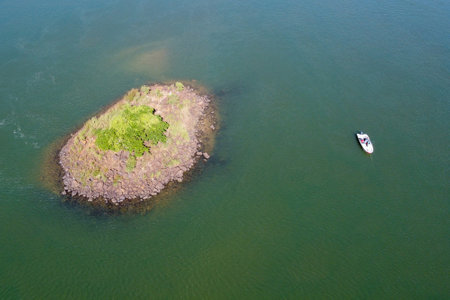 Capture the serenity of Lovers Island. A solitary boat rests on its shores, an oasis of peace on the...