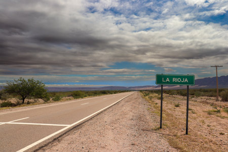 A desolate road merges with the Andean horizon in La Rioja, Argentina. An immense and majestic landscape, full of mystery and ancient legends.の写真素材