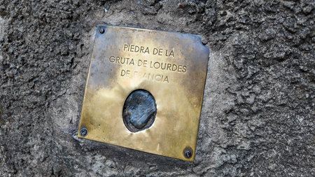 Commemorative plaque with an original stone brought from the Lourdes Grotto in France. Located in the Santos Lugares sanctuary Buenos Airesの写真素材