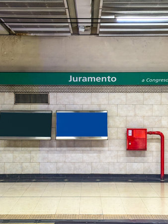 Close up of Juramento sign with hydrant and steel benches. White ceramic wall on the Belgrano...