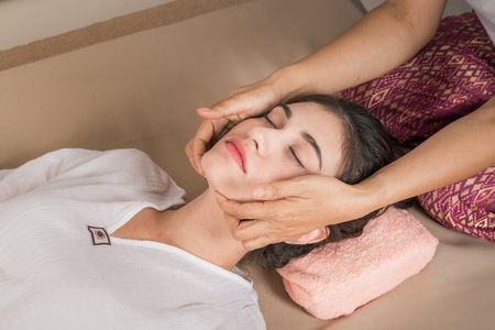 Young Girl get Thai style massage by Woman for body therapyの写真素材