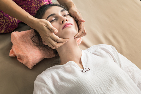 Young Girl get Thai style massage by Woman for body therapyの写真素材
