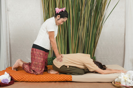 Young Girl get Thai style massage by Woman for body therapyの写真素材