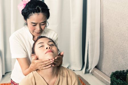 Young Girl get Thai style massage by Woman for body therapyの写真素材