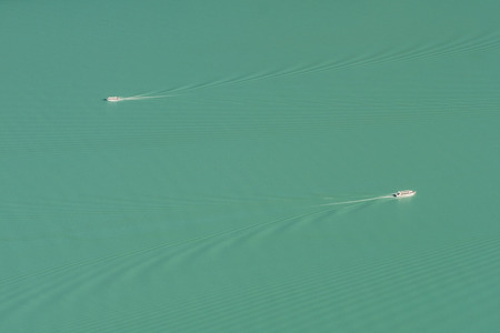 Top view minimal photo of both boats move cross each other in Kanas lake, Xinjiang, China
