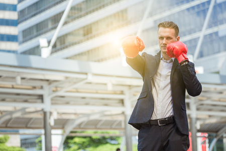 business man fighting use boxing mitts, competitor conceptの写真素材