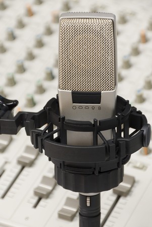Nice studio microphone in front of an audio mixer