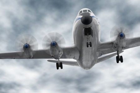 Old aircraft flying towards the camera; the worm's-eye view and dark clouds create a slightly...