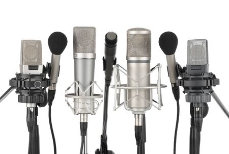 Studio shot of seven professional microphones in a row on white backgroundの写真素材