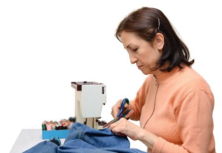 Isolated studio shot of an experienced seamstress during her workの写真素材