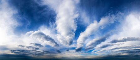 Sky panorama showing a fascinating cloudscape with deep blue color and white clouds