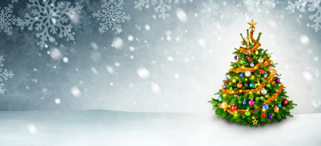Colorful shiny Christmas tree on a panoramic snow background with copy spaceの写真素材