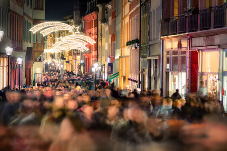 Large crowd of people hustling and shopping in a pedestrian area in Heidelberg, Germany, for Christmasのeditorial素材