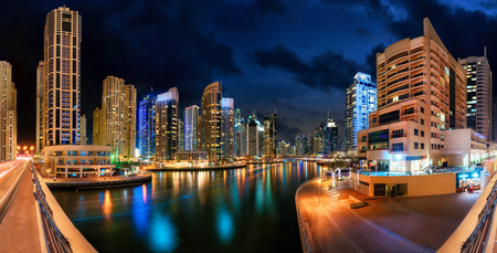 Dubai Marina at night, with the skyline and colorful reflections on the waterの写真素材