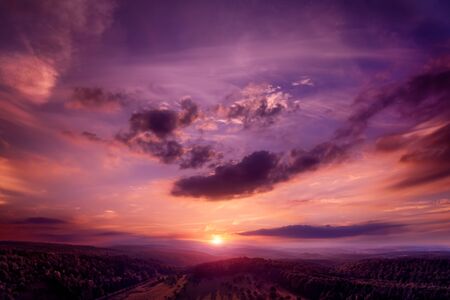 Dramatic, emotional and romantic sunset sky in dark gorgeous red and purple colorsの写真素材