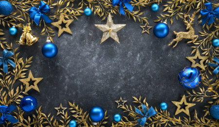 Christmas background with elegant gold adornments as a frame, blue baubles and bows, on a dark gray textured board as copy spaceの写真素材
