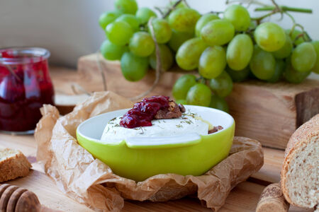 Camembert with raspberry sauce and grapesの写真素材
