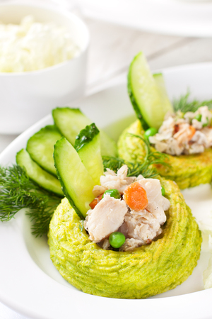 Nests made with duchess potatoes and peas stuffed with white fish ragoutの写真素材