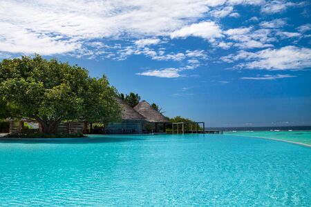 Large infinity swimming pool on Maldives resort. Luxury holiday concept.の写真素材
