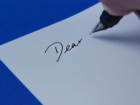 Close-up of pen writing on white paper