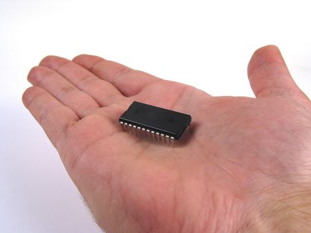 Hand holding a electronic chip on palm