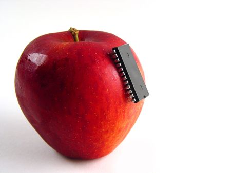 Red apple with chip attached as a symbol for bio-genetical manipulationsの写真素材