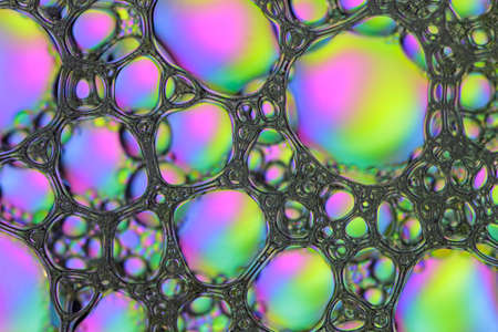 Textural Foam Surface of Soap or Shampoo with Bubbles of Pink, Yellow and Blue Colors. Abstract...