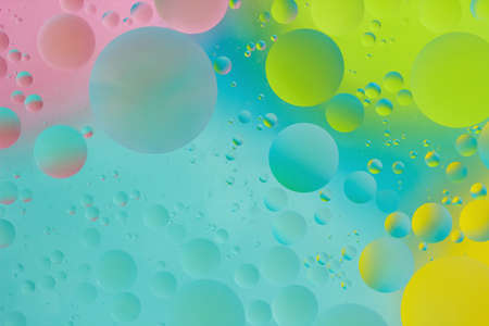 Creative Background Closeup Circles of Oil Drops in Water. Macro Photo of Liquid Surface with Blue,...