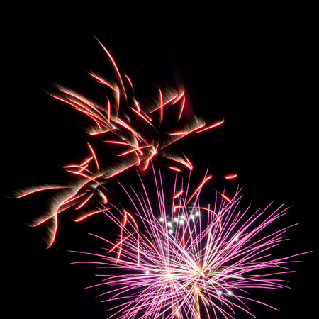red and purple fireworks on black backgroundの写真素材