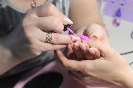 The manicure master works with the client nailsの写真素材