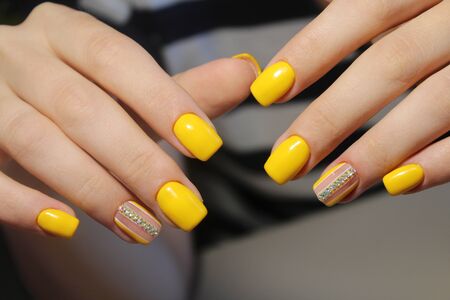 Bright manicure design of yellow nailsの写真素材