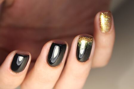 Evening manicure design in black and gold colorの写真素材