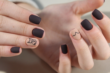 Nails black and coffee color with abstractionの写真素材