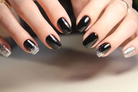Evening manicure design in black and gold colorの写真素材
