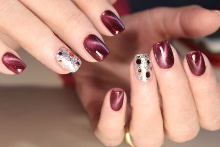 Multicolor manicure. Blue silk or leather background.の写真素材