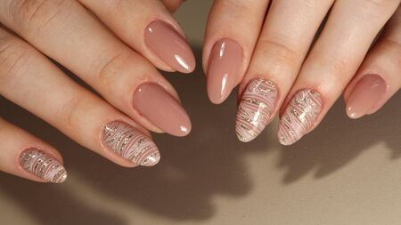 Manicure nail design on female hand close up.の写真素材