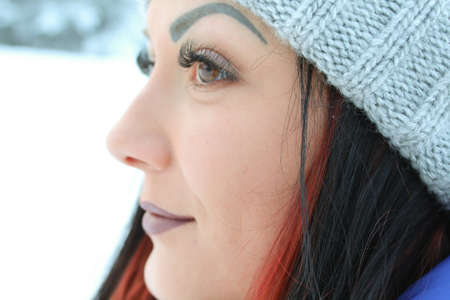 Beautiful girl in a snowy forestの写真素材