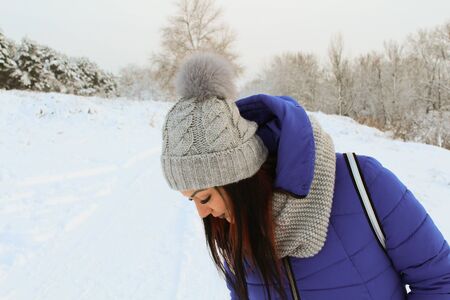 Beautiful girl with big eyes in the winter forest