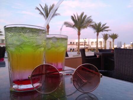 Cocktails and glasses are on the tableの写真素材