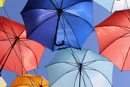 Colourful umbrellas urban street decoration. Hanging colorful umbrellas over blue sky, touristの写真素材