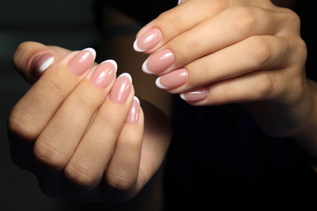 Amazing natural nails. Women's hands with clean manicure. Gel polish applied.の写真素材