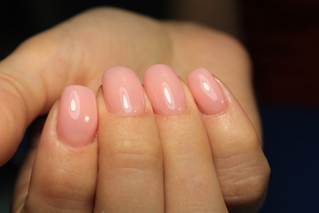 Amazing natural nails. Women's hands with clean manicure. Gel polish applied.