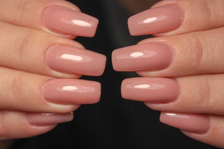 Amazing natural nails. Women's hands with clean manicure. Gel polish