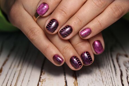 Closeup photo of a beautiful female hands with elegant manicure and diamond rings.の写真素材