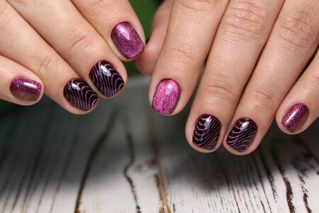 Trendy manicure design on a beautiful textural background.の写真素材